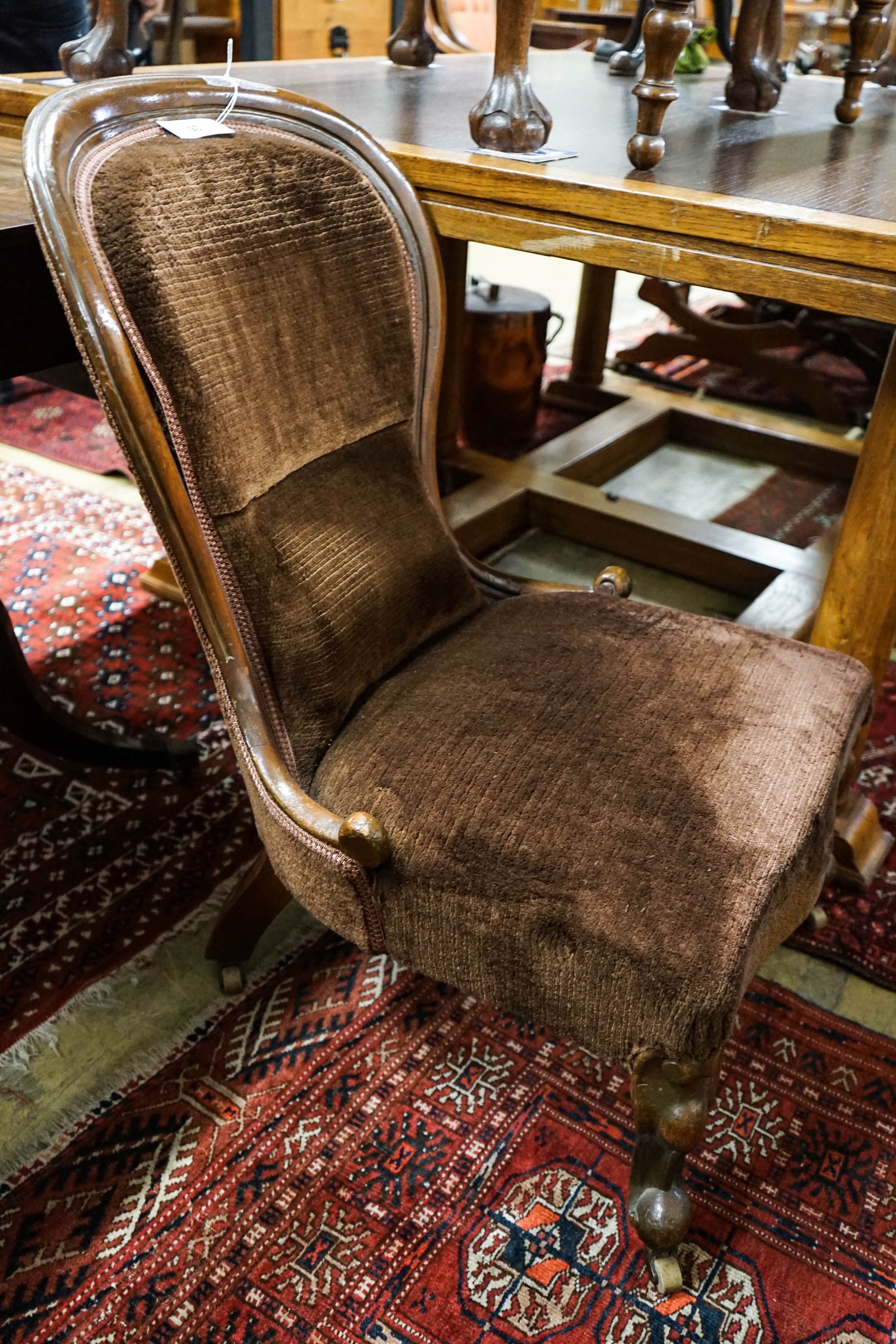A Victorian mahogany spoonback nursing chair